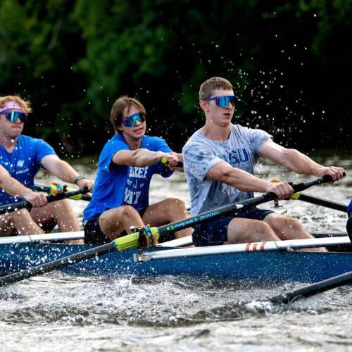 Men's rowing team members practice on the Grand River in August. (Photo by Kendra Stanley-Mills)